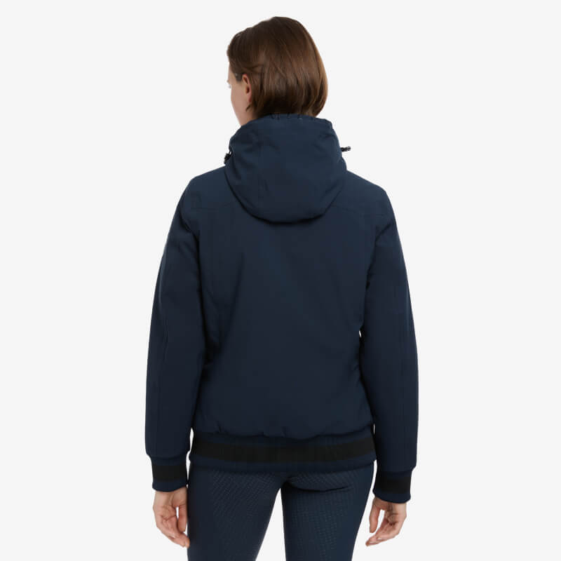 Model wears the LeMieux Ladies Team Jacket Navy, seen from the back on a white background.