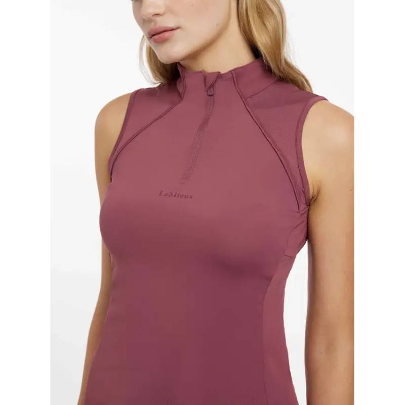 Woman in a LeMieux Maria Mesh Sleeveless Baselayer Rosewood with a short zip at the neckline.