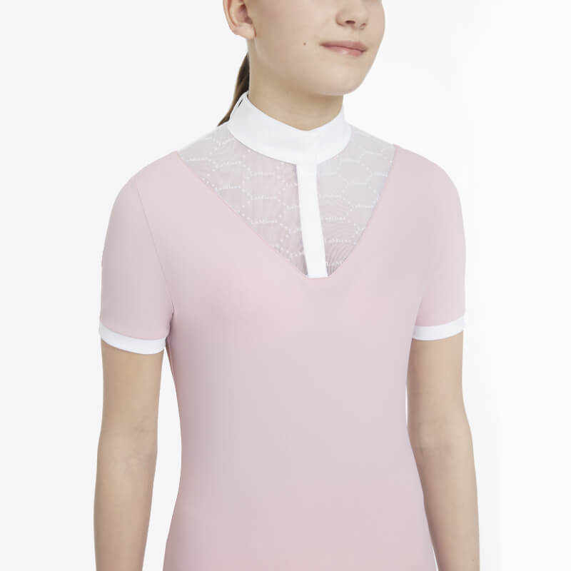 Young rider wears the LeMieux Young Rider Eva SS Show Shirt Blossom with white collar and lace.
