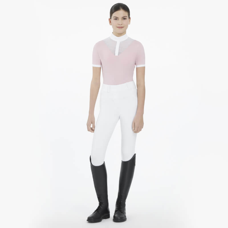 Young rider wears LeMieux Young Rider Eva SS Show Shirt Blossom with white pants and black boots.