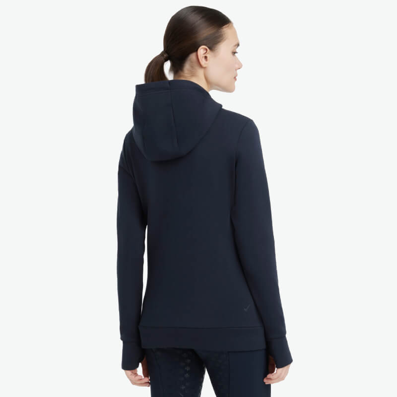Woman in LeMieux Classique Hoodie Navy, shown from the back.