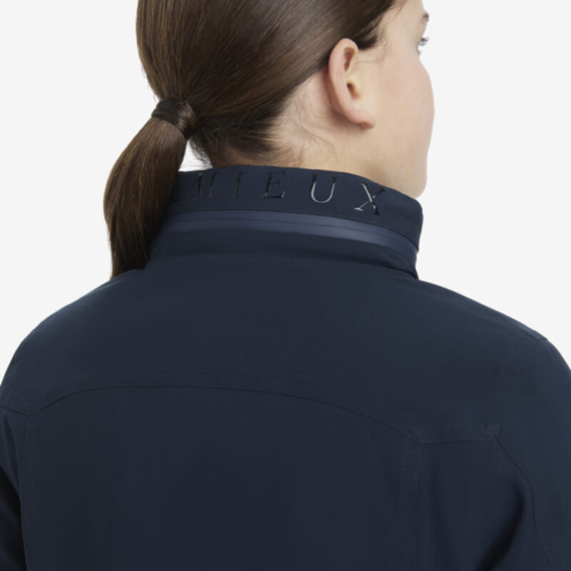 Person with brown hair in a ponytail wears a LeMieux Young Rider Team Jacket Navy.