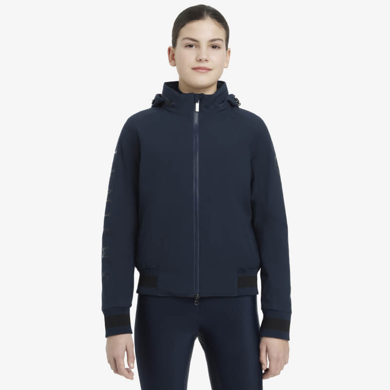 A young person wears the LeMieux Young Rider Team Jacket Navy, facing forward.