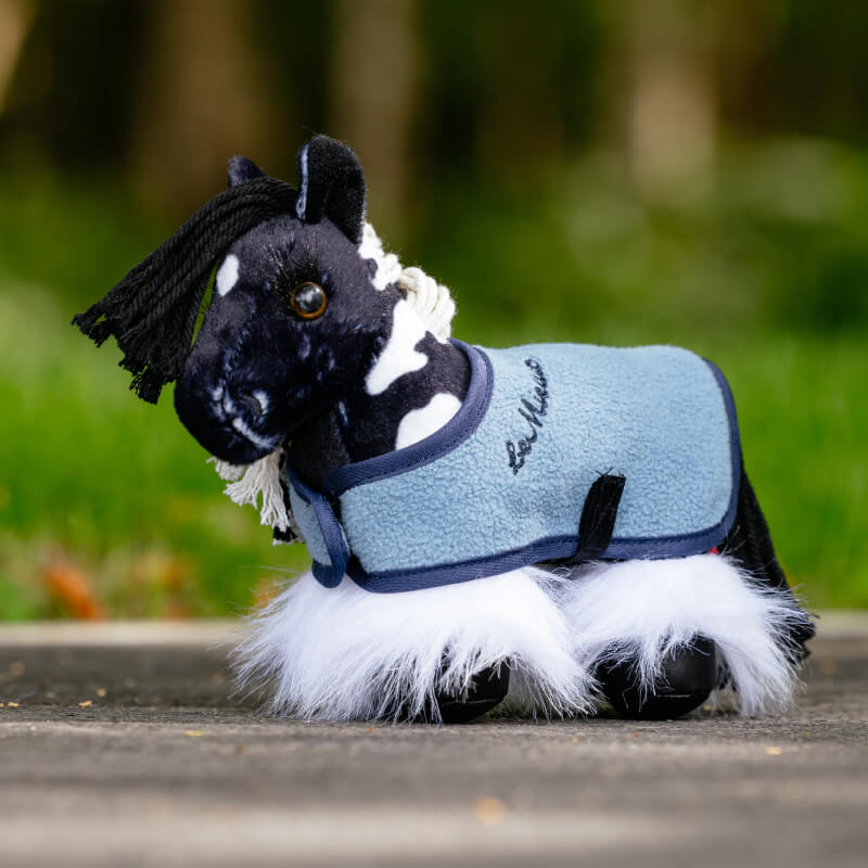 LeMieux Tiny Pony Razzle plush in blue fleece coat and white leg warmers outside.