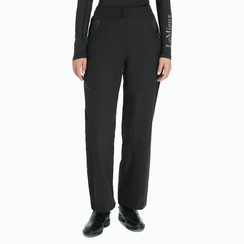 Person in LeMieux Young Rider Drytex Stormwear Waterproof Trousers Black, black shoes, and top.