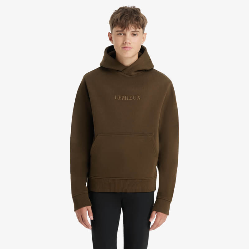 Young person wears a fleece-lined LeMieux Young Rider Boys Hoodie Alpine against a plain background.