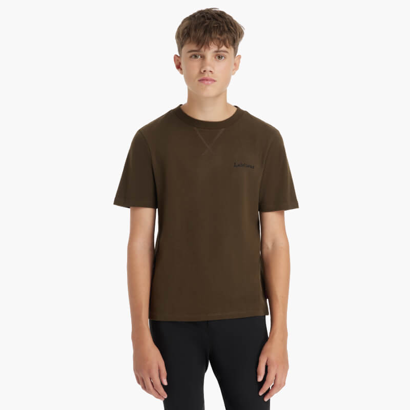 Teen boy in a LeMieux Young Rider Boys T-Shirt Alpine and black pants on a white background.