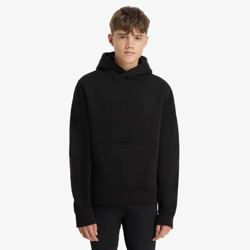 Young model in LeMieux Young Rider Boys Hoodie Black, a fleece-lined hoodie with kangaroo pocket.