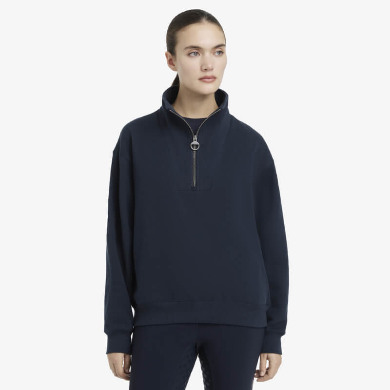 Woman in a LeMieux Keira Quarter Neck Sweat Navy stands against a white background.