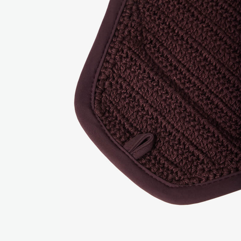 Close-up of a textured, damson LeMieux Essence Acoustic Fly Hood with looped strap and stitching.