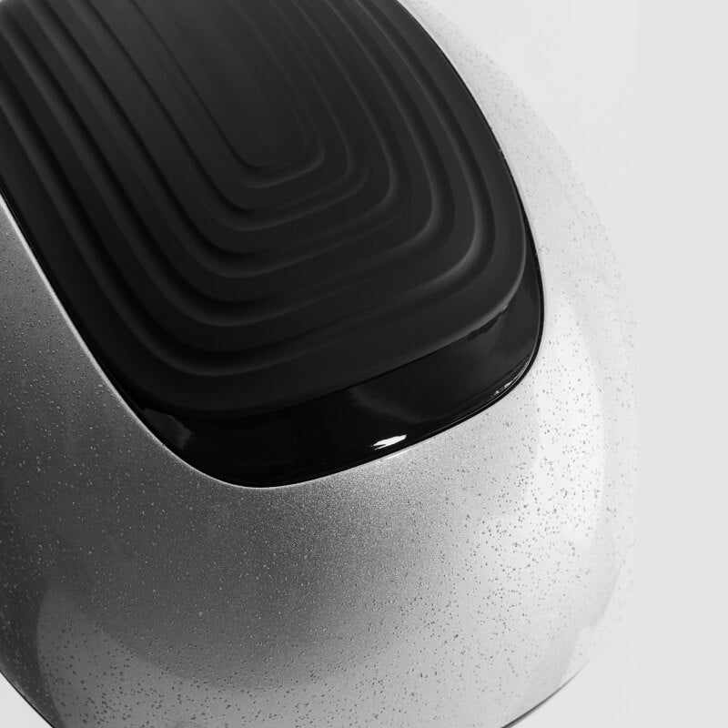 Close-up of the LeMieux Vexa® Skull Helmet Silver with a black textured top and silver finish.
