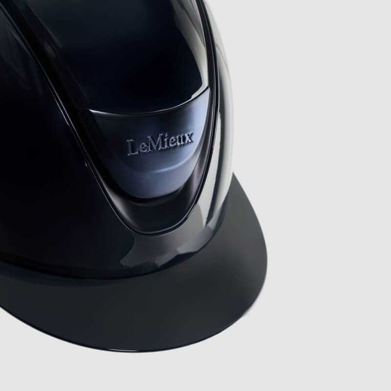LeMieux Verv® Gloss Navy helmet with chin strap and enhanced rider protection.
