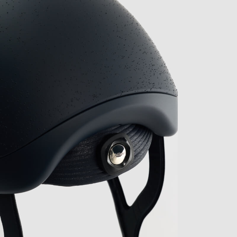 LeMieux Vexa® Skull Helmet Navy with raindrops, metallic knob, and visible straps below.