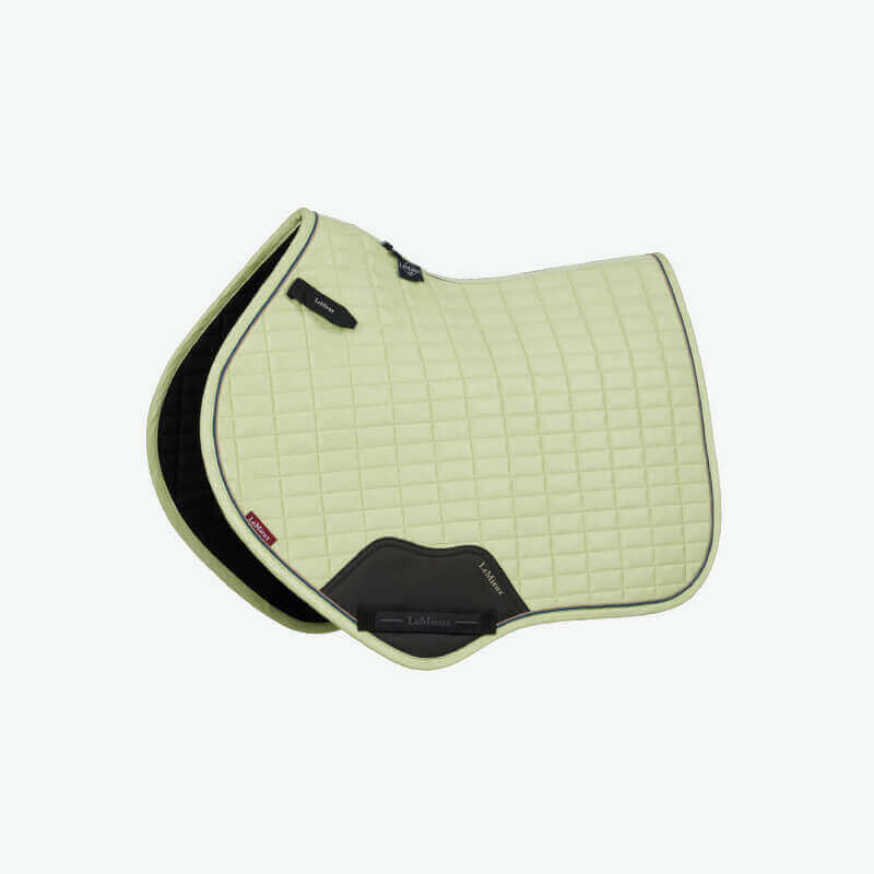 LeMieux Suede Close Contact Square Macaron saddle pad in light green with black trim and patches.