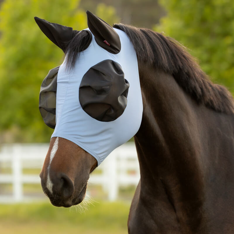 LeMieux Bug Relief Half Fly Mask in powder blue shields horses from bugs and UV rays outdoors.