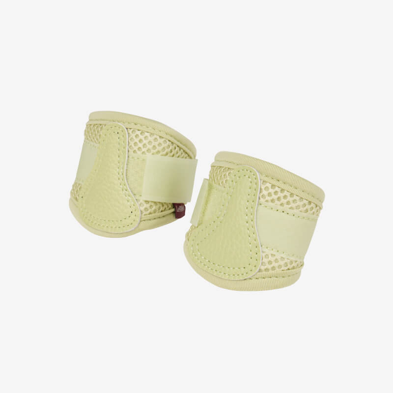 Two LeMieux Toy Pony Mesh Brushing Boots Macaron in beige on a white background.