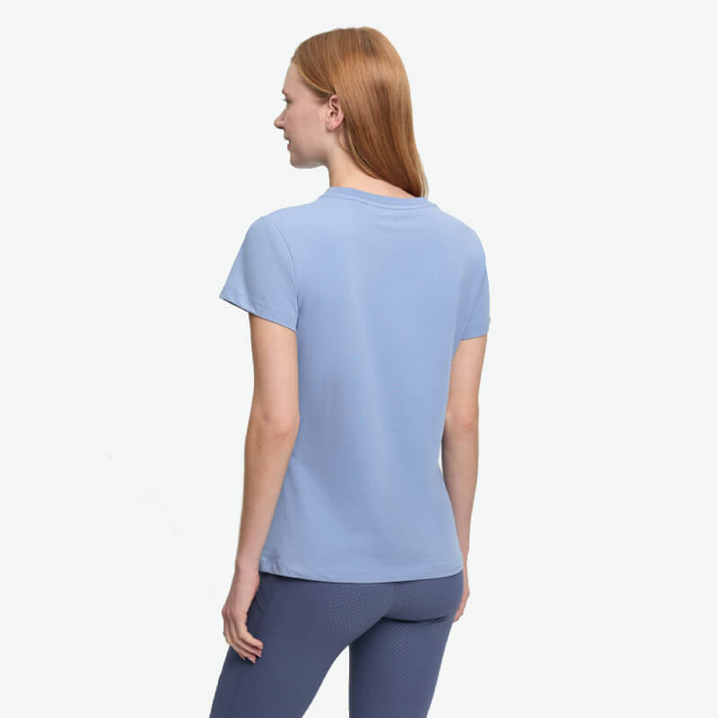 Woman in LeMieux Classique T-Shirt Powder Blue, showcasing equestrian style from behind.