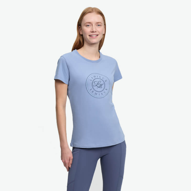 Woman in a LeMieux Classique T-Shirt Powder Blue, smiling against a white background.