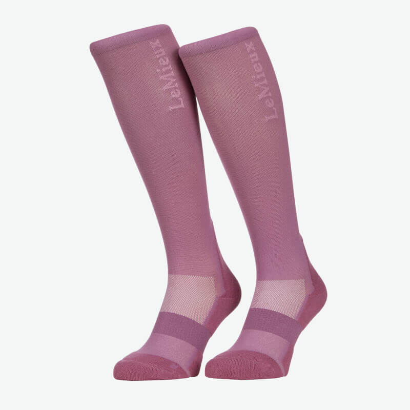 A pair of LeMieux Performance Socks Mallow, knee-high and pink, stand on a white background.