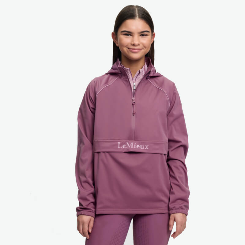 Person in a LeMieux Young Rider Paige Quarter Zip Waterproof Jacket Mallow, on white background.