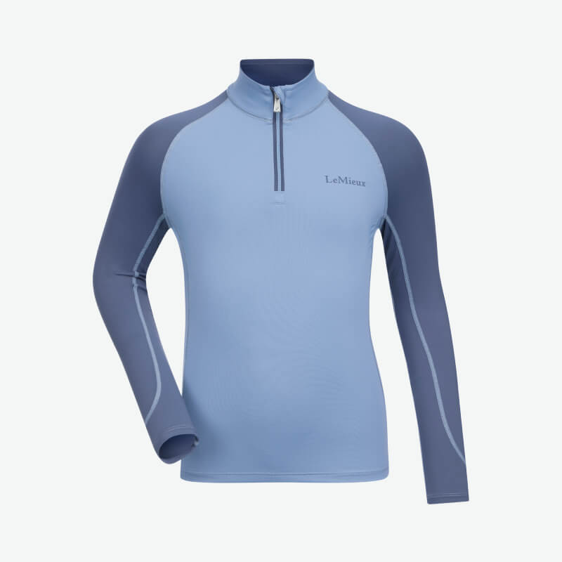 LeMieux Mini Baselayer in Powder Blue, a moisture-wicking kids’ riding top with dark sleeves.