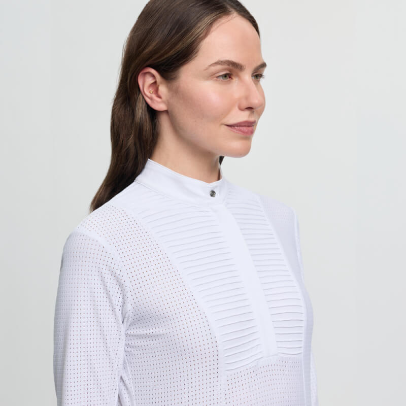 Woman wears the LeMieux Arielle Long Sleeve Show Shirt in white, looking to the side.
