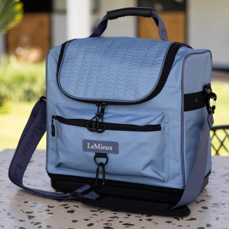 LeMieux Elite Pro Grooming Bag Powder Blue, one size, on outdoor table with front pocket.