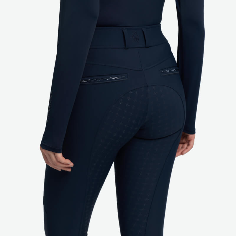 Wearing LeMieux Brilliance Full Seat Breeches Navy with textured seat and back zip pockets.