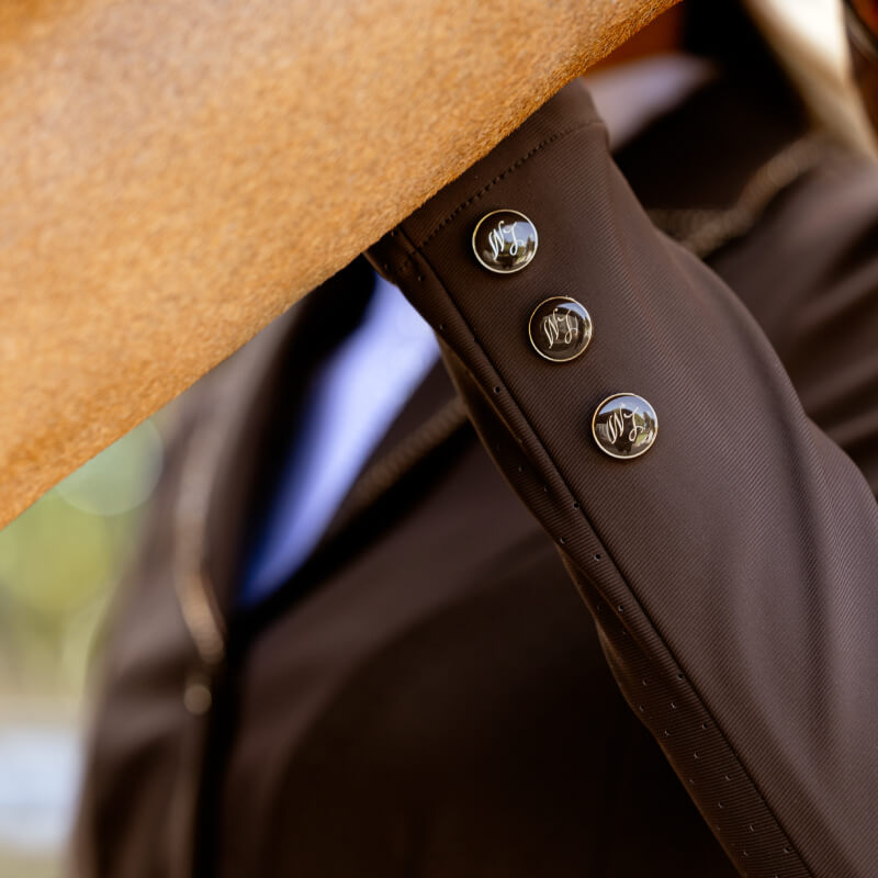 Close-up of LeMieux Brilliance Diana Show Jacket Espresso sleeve with three buttons.