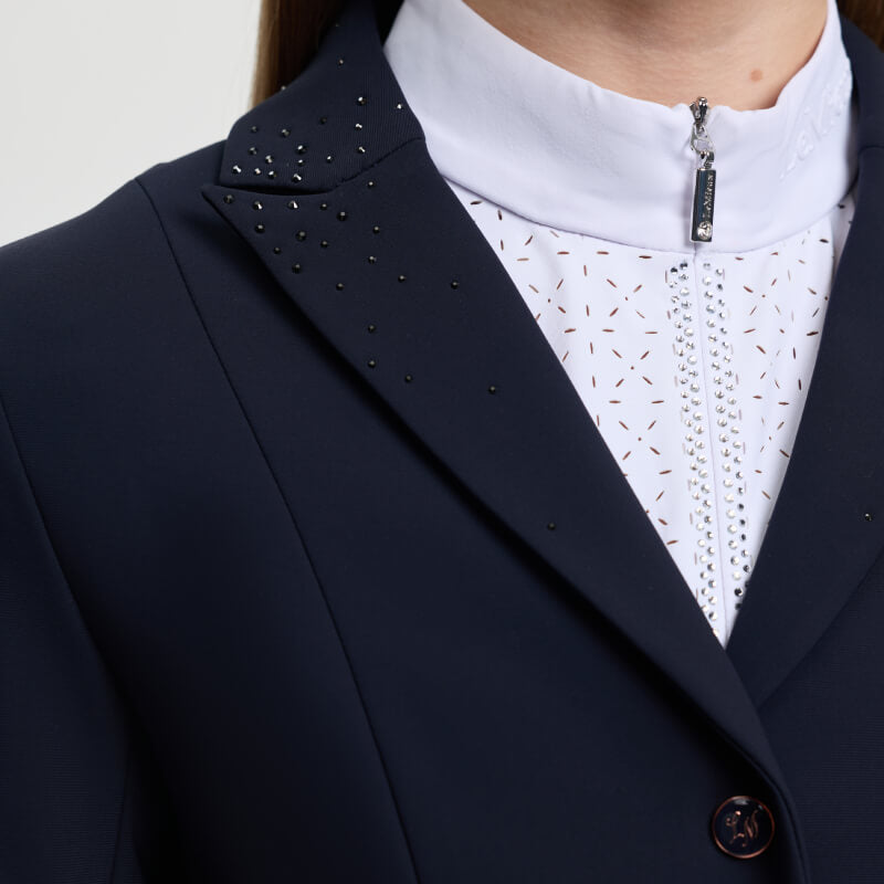 Young riders in the LeMieux Brilliance Junior Pro Show Jacket Navy and a white zippered shirt.