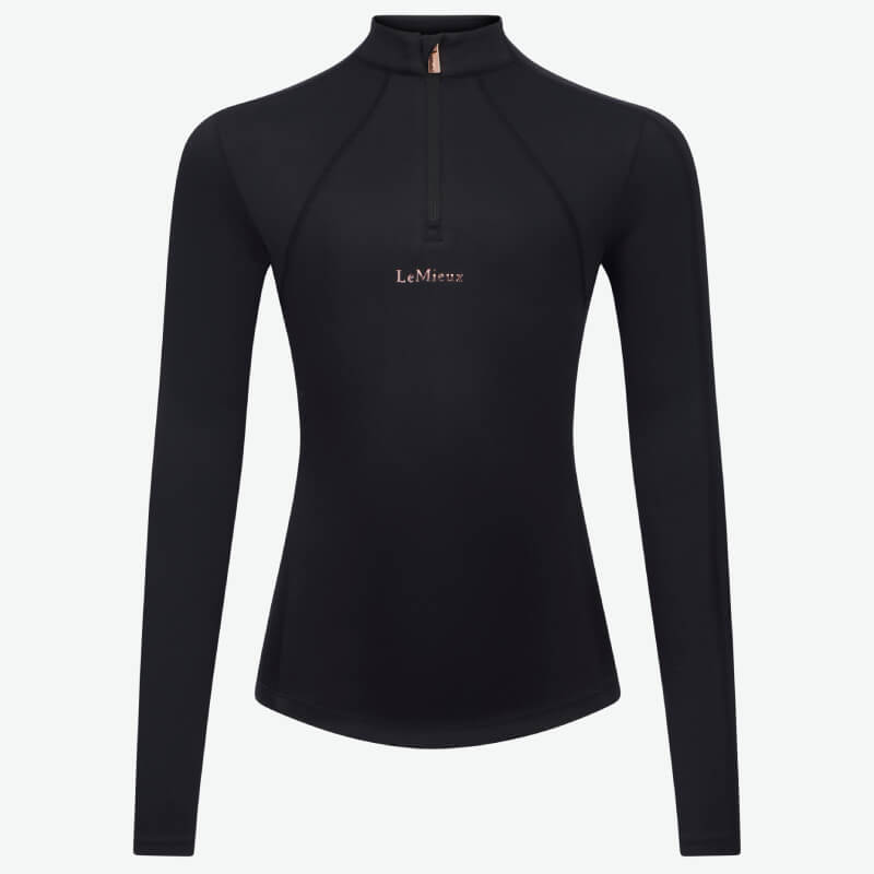 Woman wearing a black LeMieux Young Rider Sparkle Baselayer, standing and smiling.