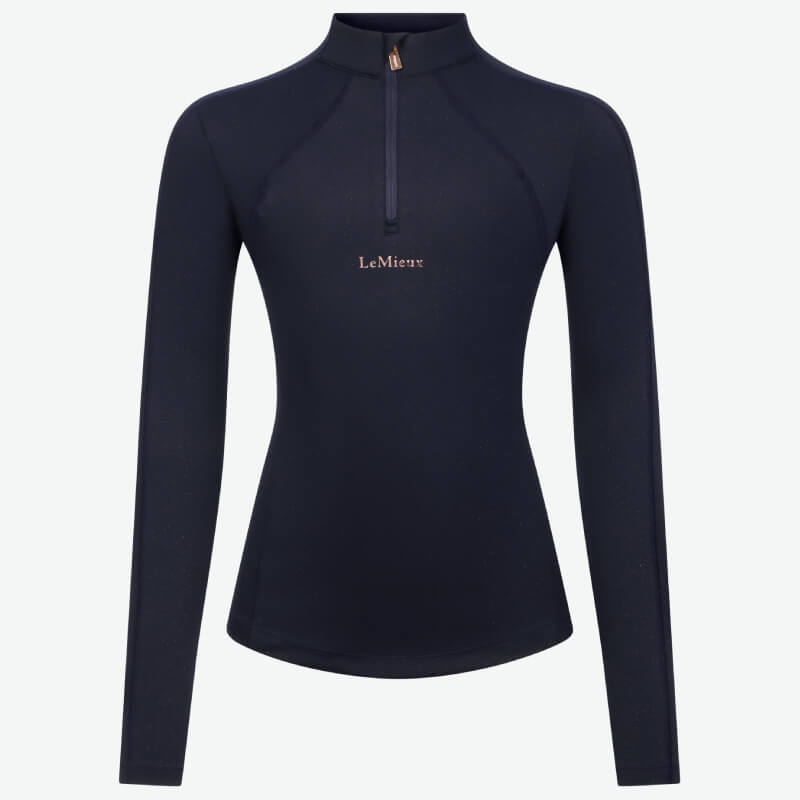 Young rider in LeMieux Young Rider Sparkle Baselayer Navy, standing and smiling.