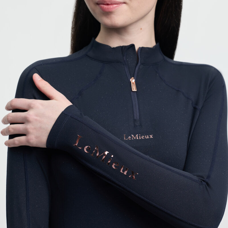 Young rider in the LeMieux Young Rider Sparkle Baselayer Navy with logo on her sleeve.
