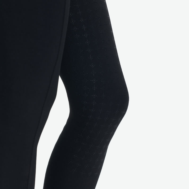 Young rider wears LeMieux Young Rider Sparkle Orla Pull On Black tights against white background.