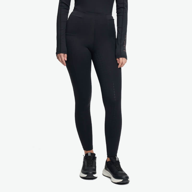 Young rider wears LeMieux Young Rider Sparkle Orla Pull On Black tights, black top, and sneakers.