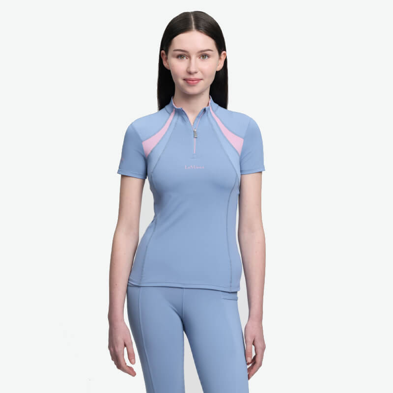 Woman in LeMieux Young Rider Mia Mesh Baselayer Powder Blue, against a white background.