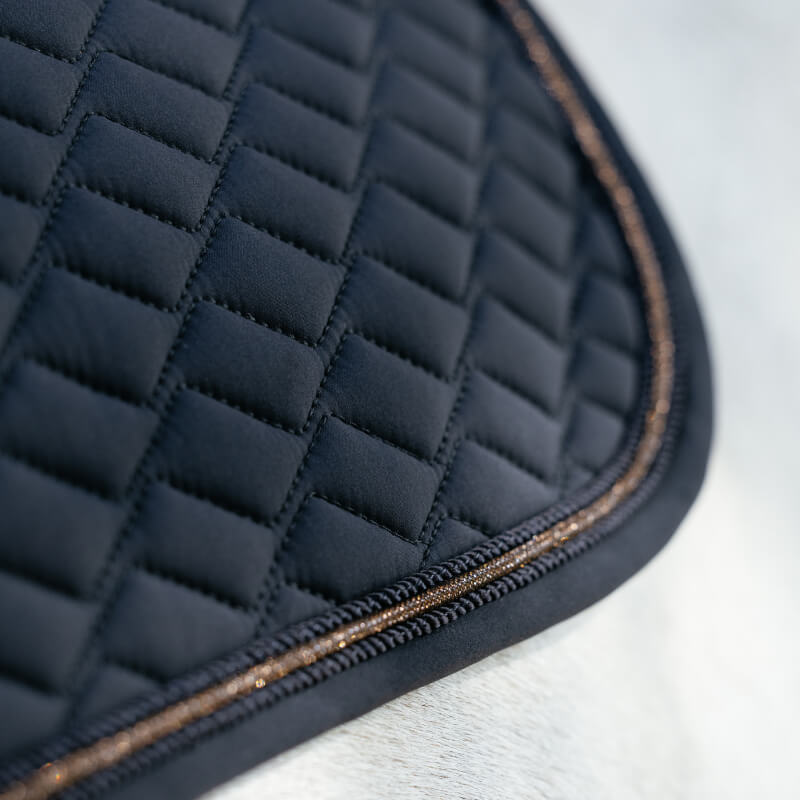 Close-up of LeMieux Brilliance Close Contact Square Navy: quilted fabric, self-cool lining, gold trim.