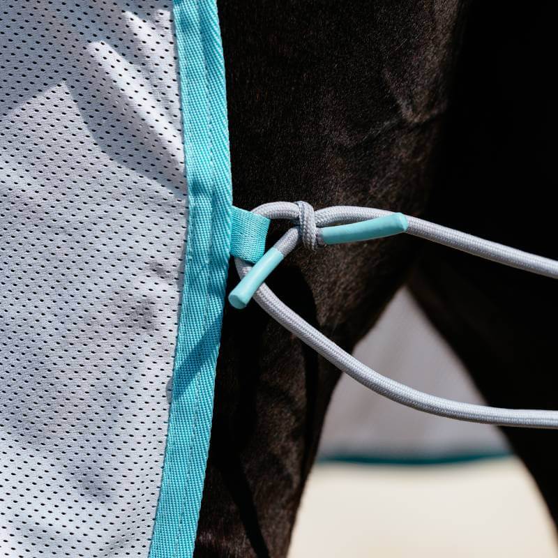 Close-up of the LeMieux Crystal Cooler Grey rug secured with gray elastic straps.
