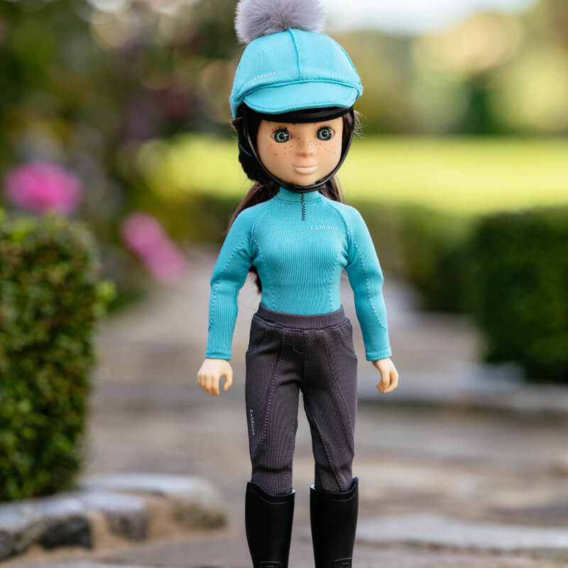 LeMieux Toy Rider Florence doll wears a blue helmet, blue top, grey pants, and black boots.