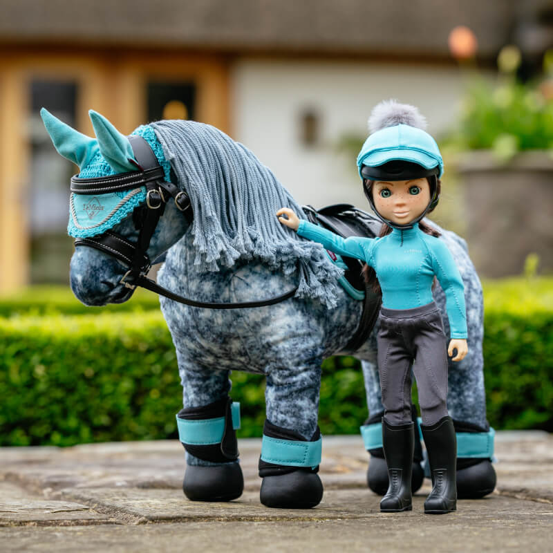 LeMieux Toy Rider Florence stands by a plush horse with blue accessories for equestrian play.