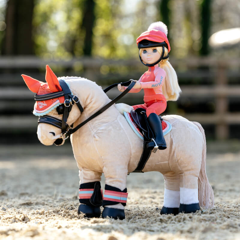The LeMieux Harlow Toy Rider Coral Crush doll inspires outdoor horse play.