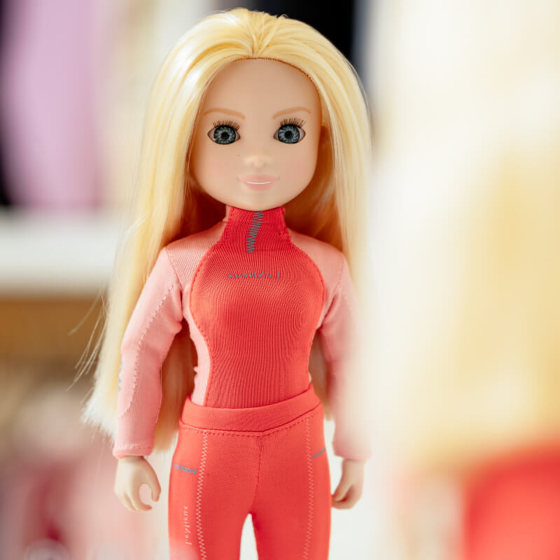 LeMieux Harlow Toy Rider Coral Crush doll stands facing forward in red and pink attire.