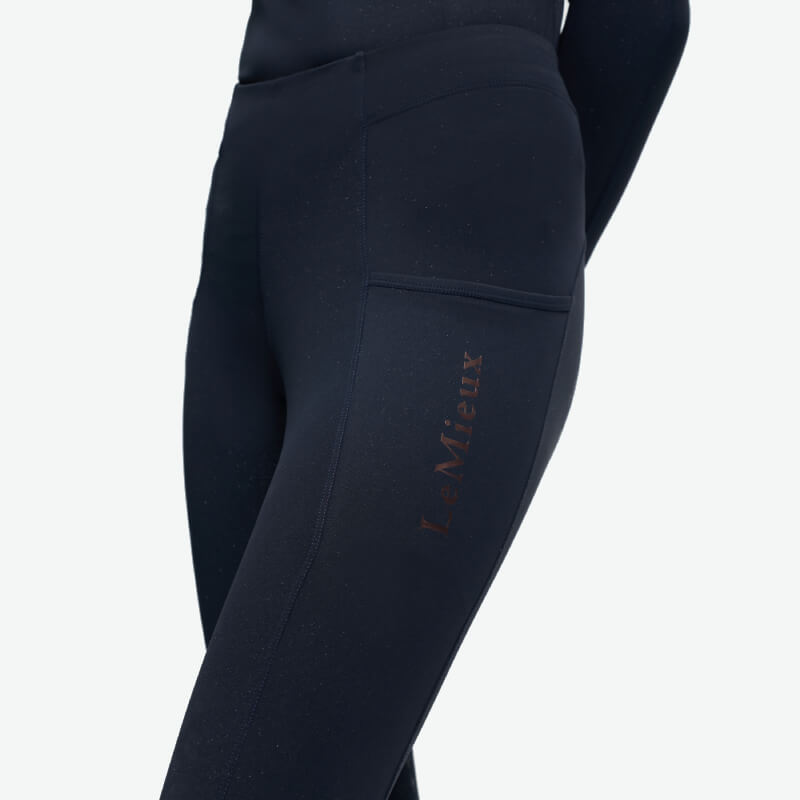 Close-up of young rider in LeMieux Young Rider Sparkle Orla Pull On Navy tights with side pocket.