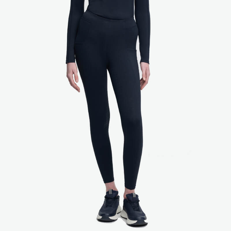Wearing LeMieux Young Rider Sparkle Orla Pull On Navy tights and a black top, with sneakers.