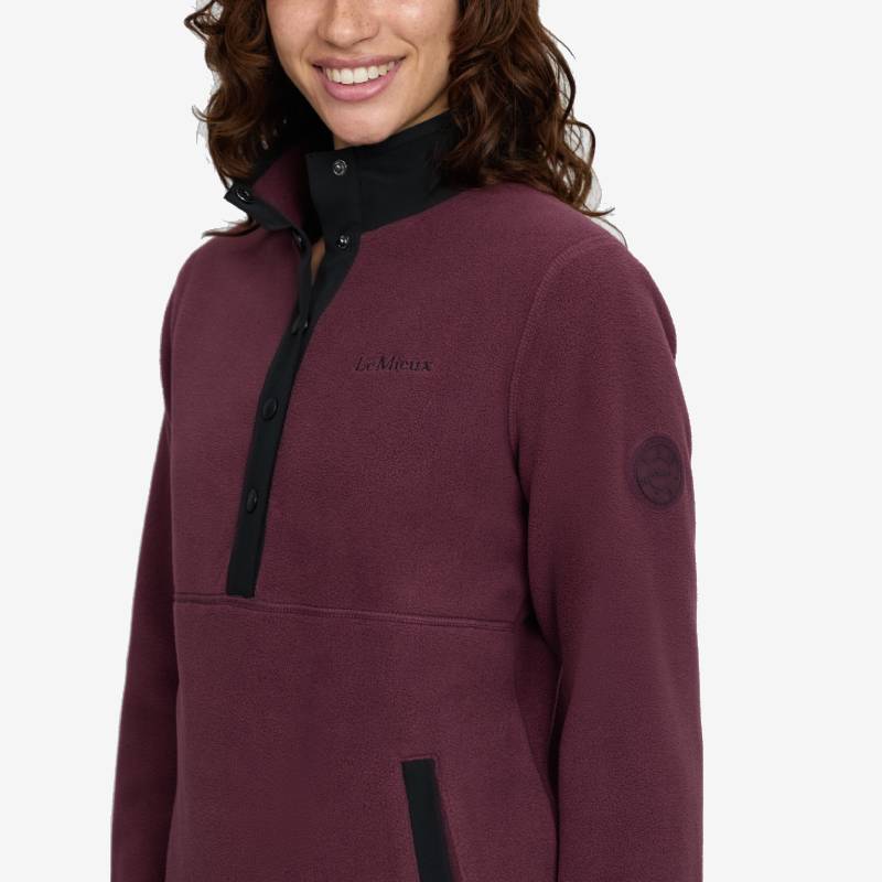 Woman smiles in a LeMieux Piper Popper Fleece Bramble by LeMieux.
