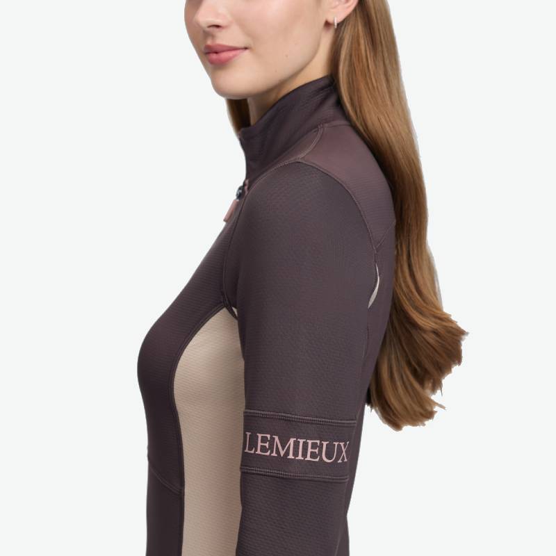 Woman in LeMieux Matila Midlayer Cocoa, side profile, with text on sleeve.