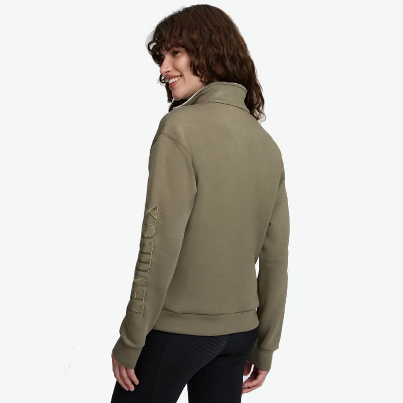 Person in LeMieux Scarlet Quarter Zip Sweat Willow Green, facing away on plain background.