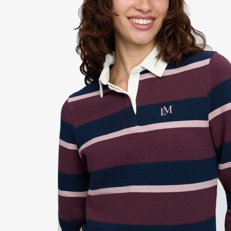 Woman in a LeMieux Sloane Stripe Rugby Shirt Bramble with a white collar, embroidered LM.