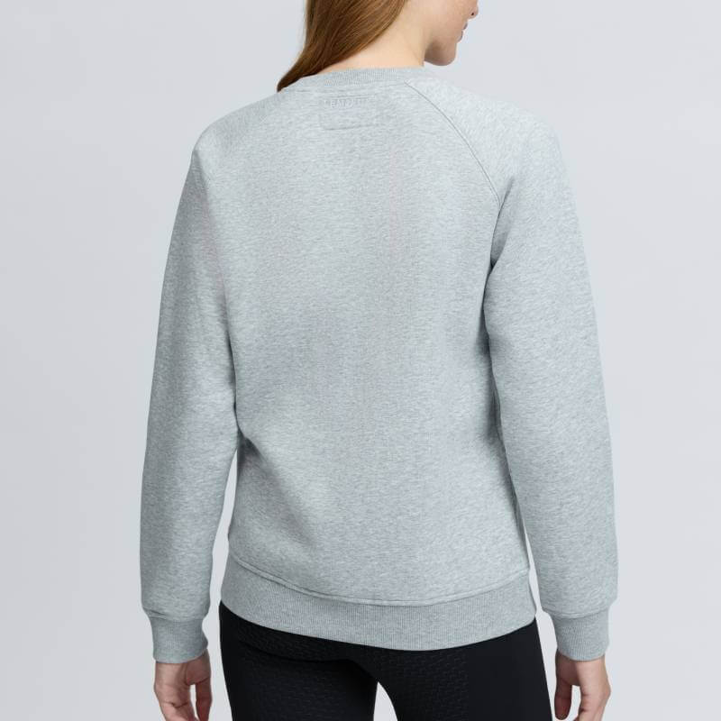 Woman in LeMieux Vida Varsity Crew Neck Sweat Grey Marl, long hair, facing away.