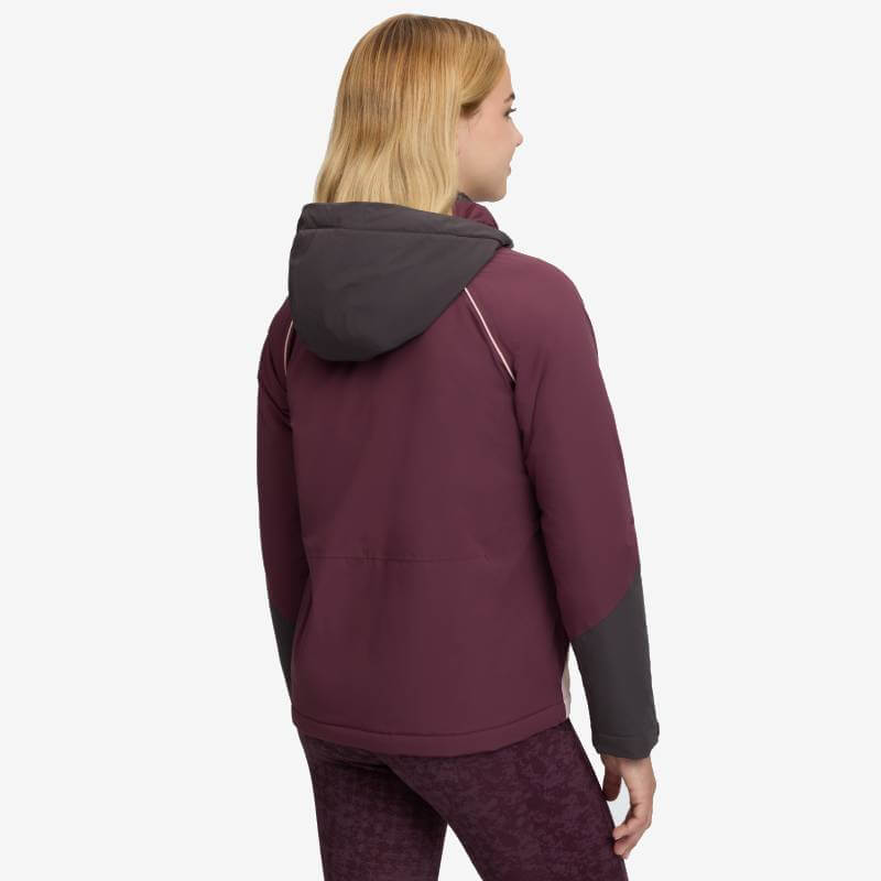 Wearing a LeMieux Young Rider Bailey Waterproof Anorak Bramble, gray hood and sleeves, back view.